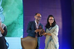 Shahariar Alam, Sr. Coordinator-Resource Mobilization hands over a crest to Shakila Sattar Trina, Executive Director of The Earth